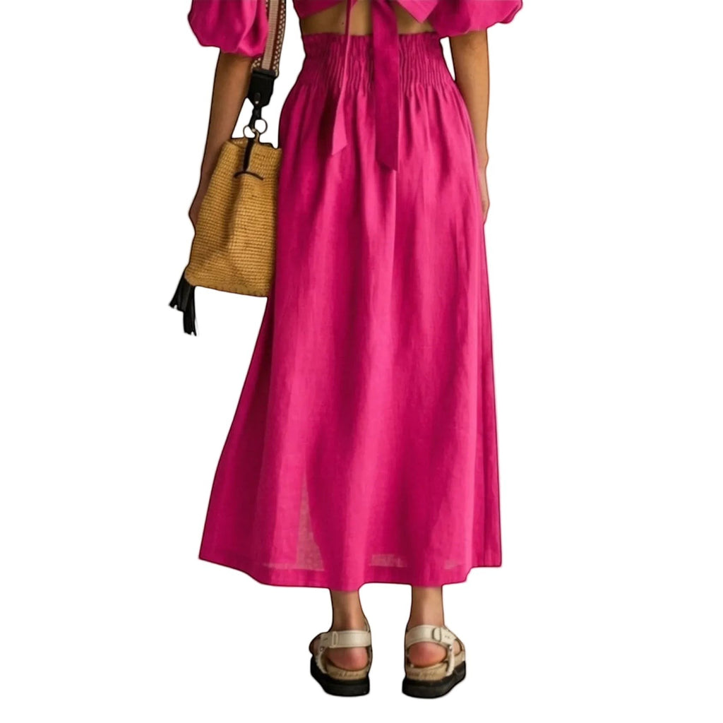 Falda maxi fucsia REVES de cintura alta con abertura frontal y banda elástica. Tejido ligero y fluido.