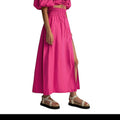 Falda maxi fucsia de REVES con cintura alta elástica y abertura frontal. Tejido ligero.