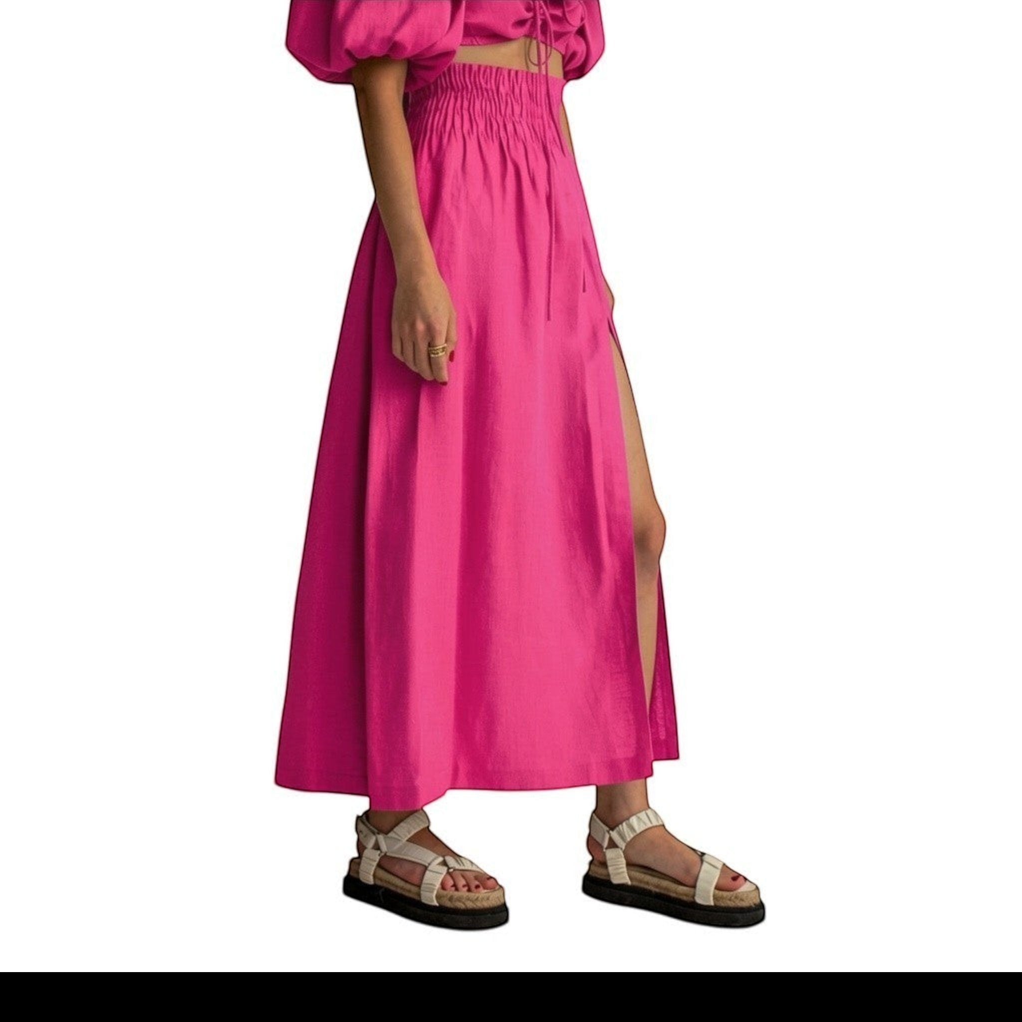 Falda maxi fucsia de REVES con cintura alta elástica y abertura frontal. Tejido ligero.